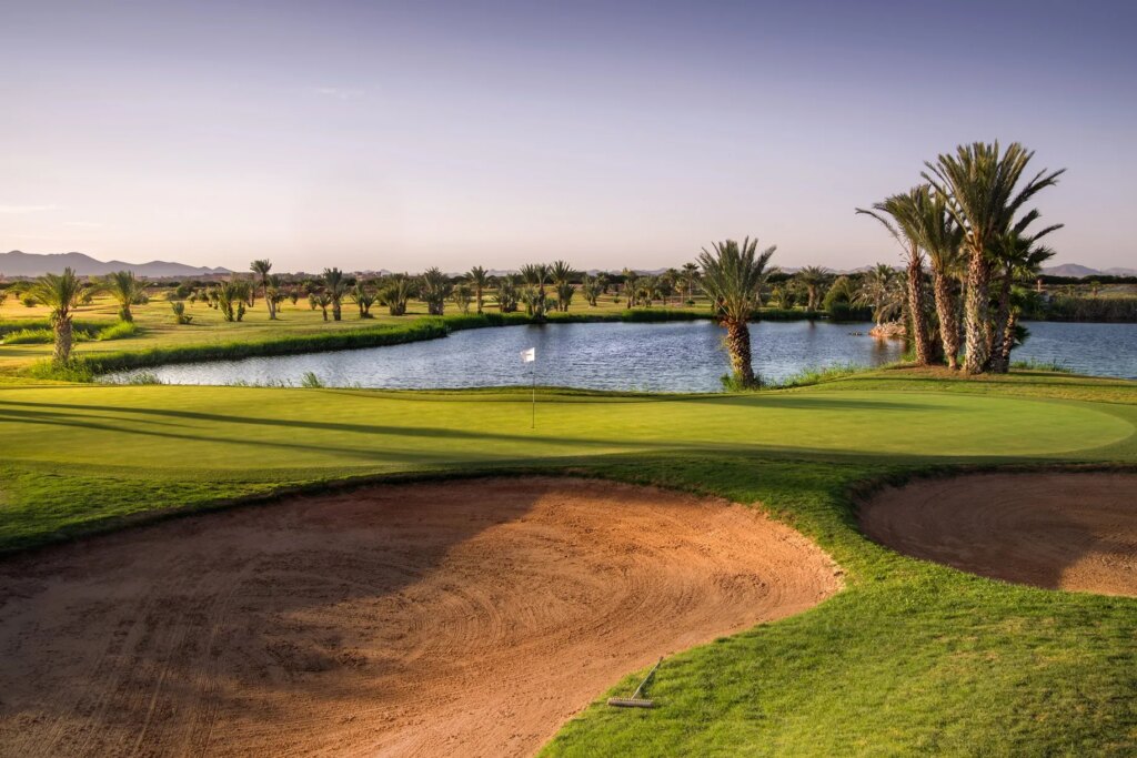 PalmGolf Marrakech Palmeraie golf course with lake and palm trees in Morocco.
